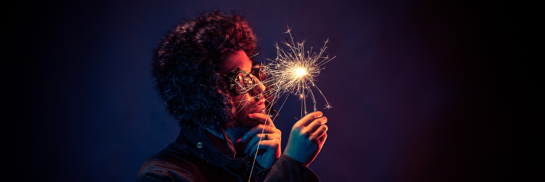 A man holding a candle and looking thoughtfully